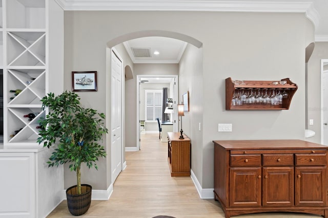 hall featuring crown molding and light hardwood / wood-style flooring