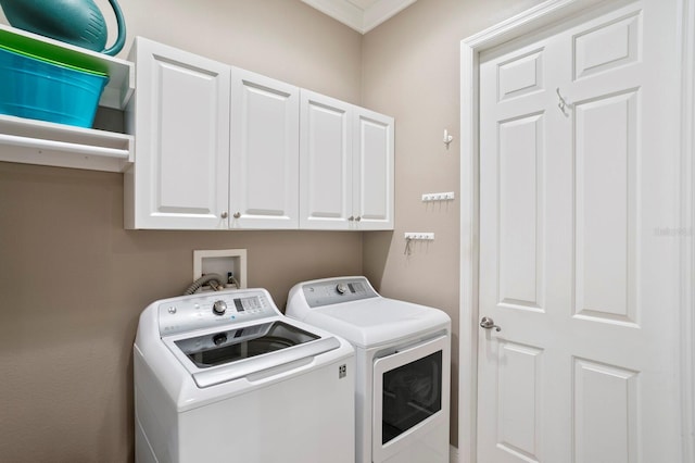 laundry area featuring cabinets and washing machine and clothes dryer