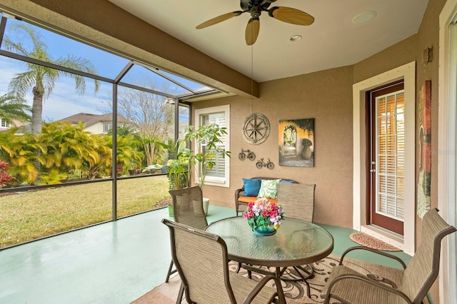 sunroom featuring ceiling fan