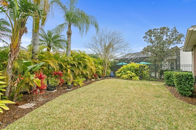 view of yard with glass enclosure