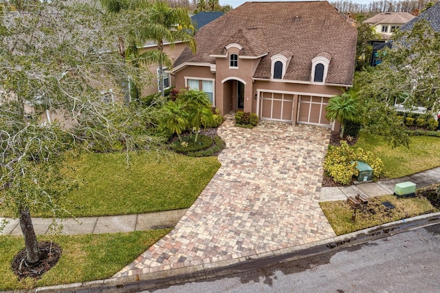 view of front of home featuring a garage and a front lawn