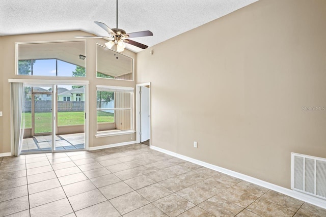 tiled empty room with high vaulted ceiling, a textured ceiling, and ceiling fan