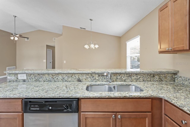 kitchen with lofted ceiling, sink, light stone countertops, and dishwasher