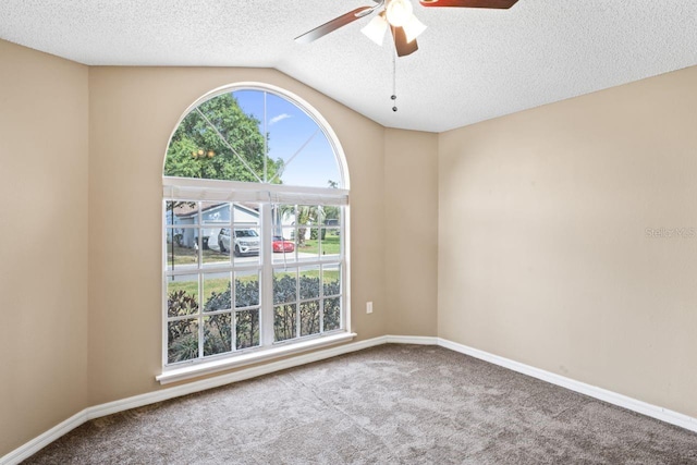 unfurnished room with vaulted ceiling, carpet, a textured ceiling, and ceiling fan