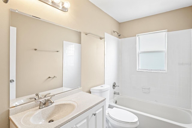 full bathroom with vanity, tiled shower / bath combo, and toilet