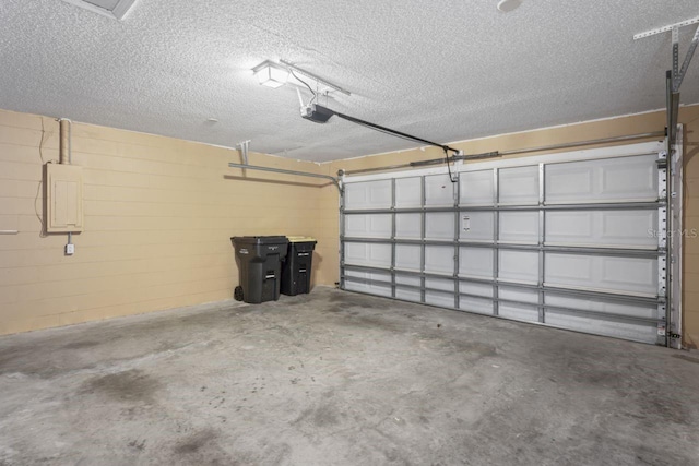 garage with a garage door opener and electric panel