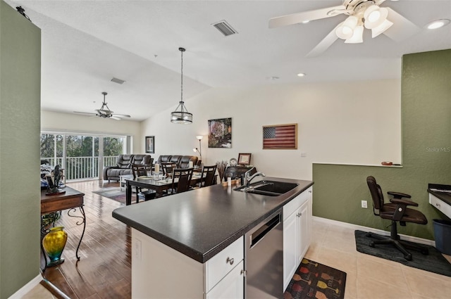 kitchen with decorative light fixtures, dishwasher, white cabinetry, sink, and an island with sink