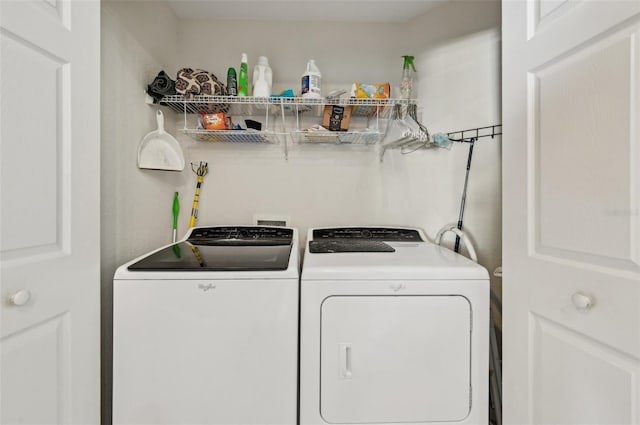 clothes washing area with washer and clothes dryer