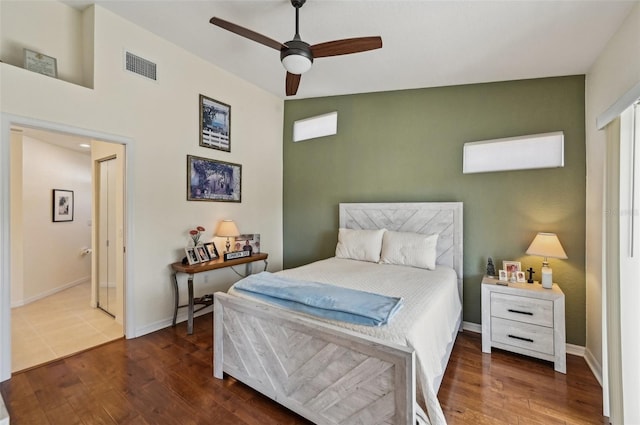 bedroom with dark hardwood / wood-style flooring