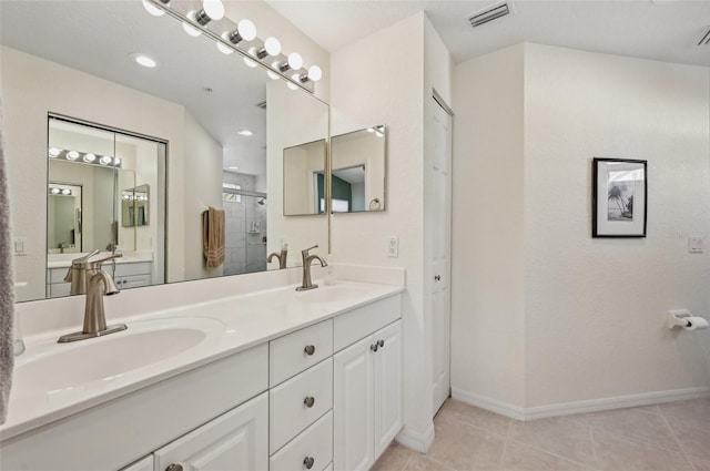 bathroom featuring vanity, a shower with shower door, and tile patterned floors