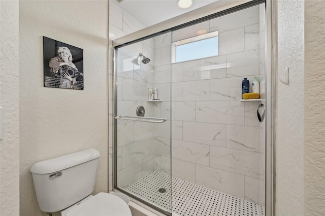 bathroom featuring walk in shower and toilet