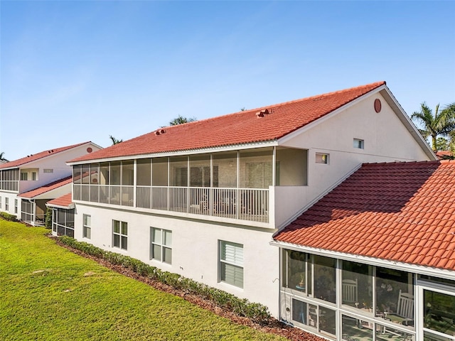 rear view of property with a lawn