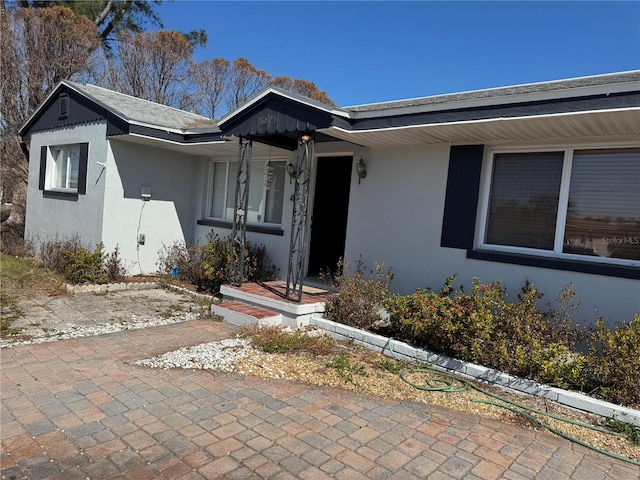 property entrance with stucco siding