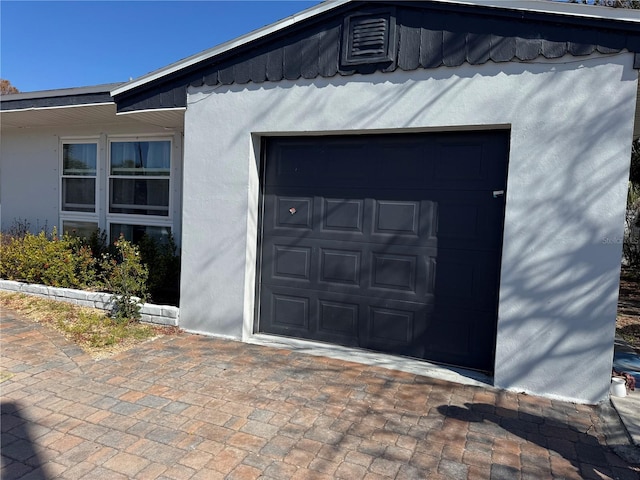 garage featuring decorative driveway