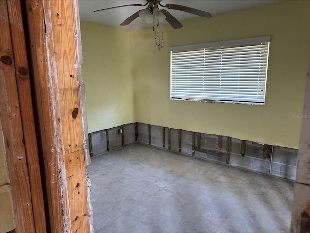 spare room with concrete flooring and ceiling fan