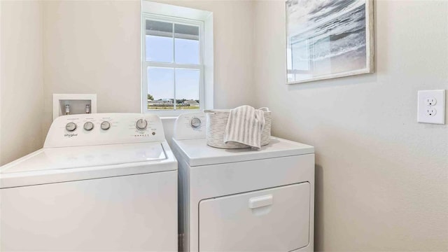 clothes washing area with separate washer and dryer