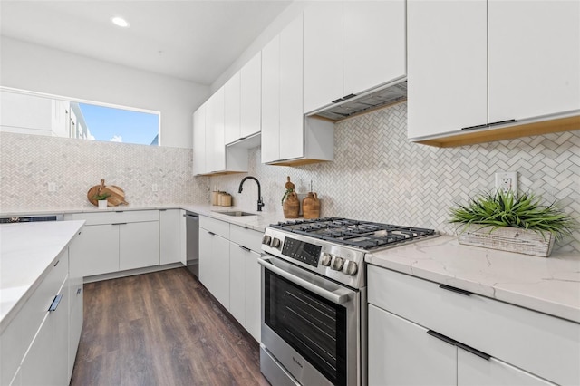 881 6th Ave S, Saint Petersburg, FL 33701 - kitchen with light stone counters, decorative backsplash, appliances with stainless steel finishes, white cabinets, and a sink