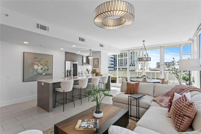 living room with floor to ceiling windows and a chandelier