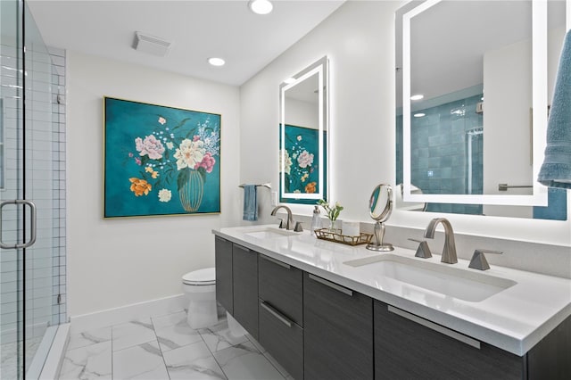 bathroom featuring vanity, a shower with shower door, and toilet