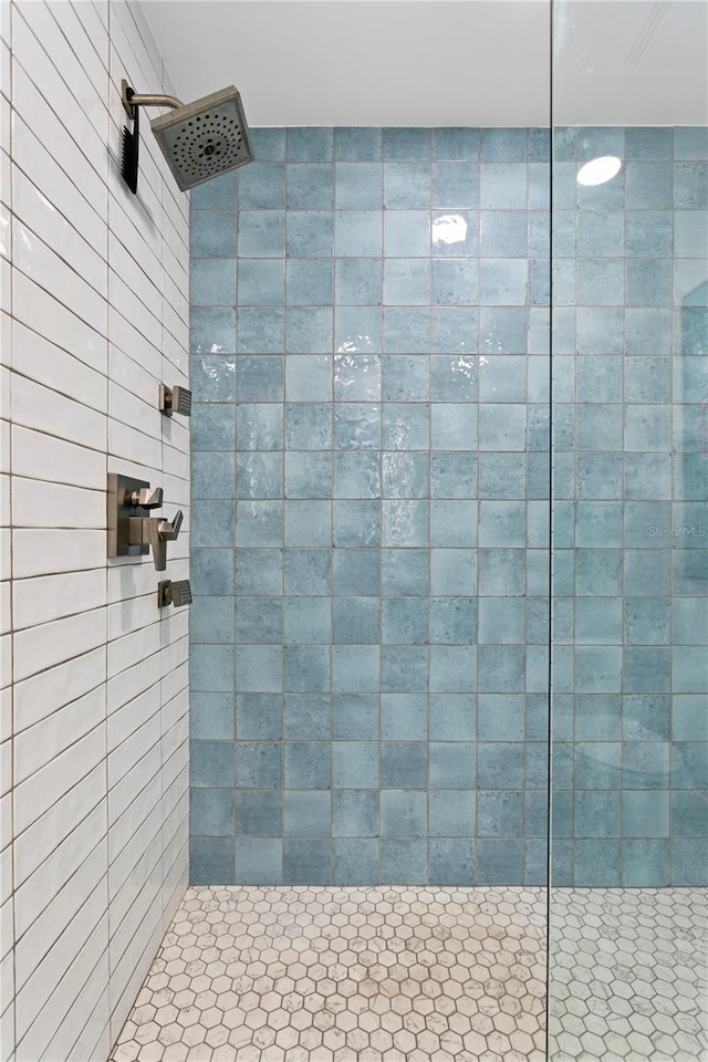 bathroom with tiled shower