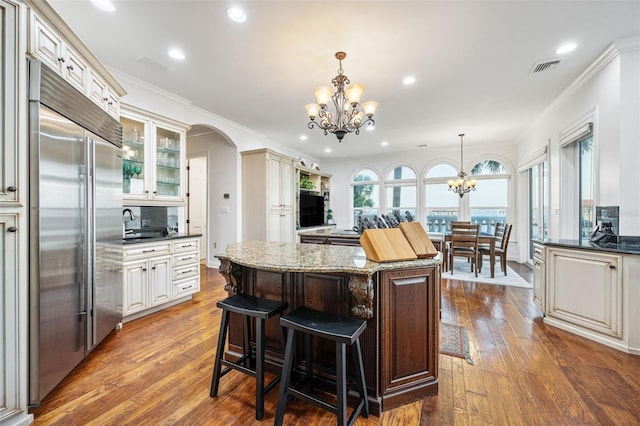 2186 Rockledge Dr, Rockledge, FL 32955 - kitchen featuring dark stone countertops, a notable chandelier, a kitchen island, hanging light fixtures, and stainless steel built in fridge
