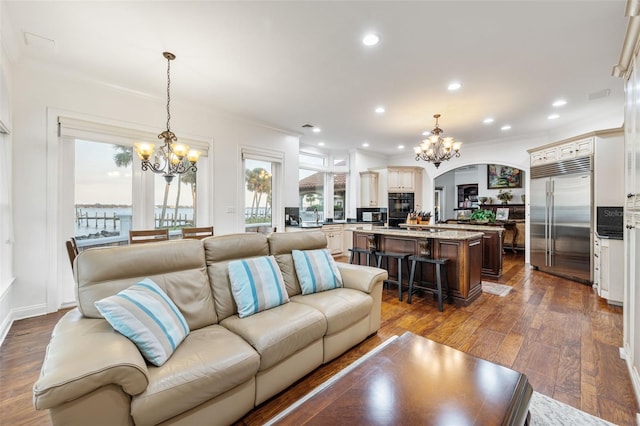 2186 Rockledge Dr, Rockledge, FL 32955 - living room featuring ornamental molding, an inviting chandelier, and dark hardwood / wood-style floors