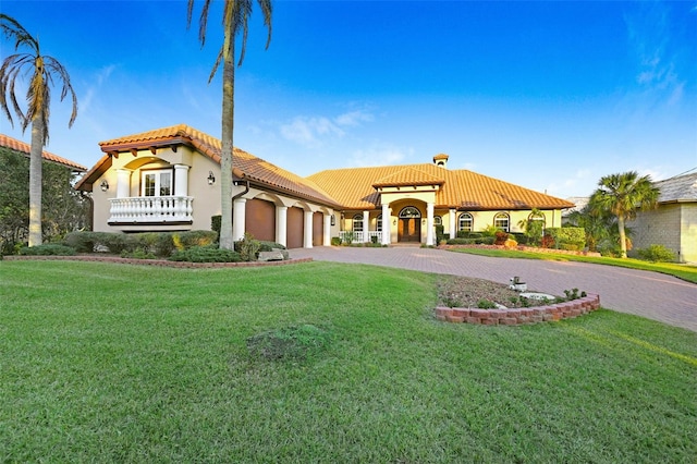 2186 Rockledge Dr, Rockledge, FL 32955 - mediterranean / spanish house featuring a front lawn and a garage