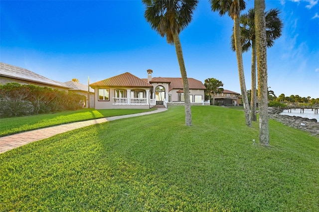 2186 Rockledge Dr, Rockledge, FL 32955 - mediterranean / spanish home featuring a water view and a front lawn