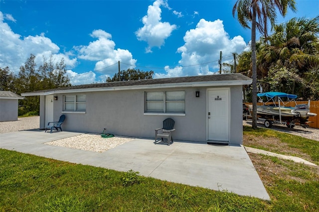 8820 Rocky Creek Dr, Tampa, FL 33615 - back of house with a patio area and a lawn