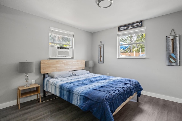 8820 Rocky Creek Dr, Tampa, FL 33615 - bedroom featuring cooling unit, dark wood-type flooring, and multiple windows