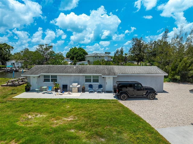 8820 Rocky Creek Dr, Tampa, FL 33615 - ranch-style home with a front yard, a patio, and a water view