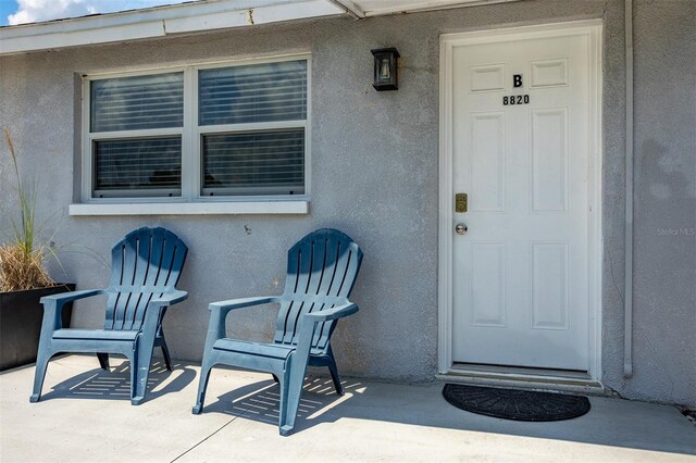 8820 Rocky Creek Dr, Tampa, FL 33615 - view of exterior entry with a patio area
