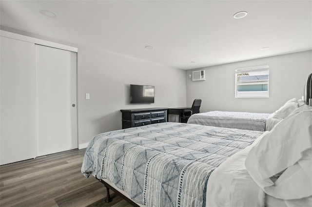 8820 Rocky Creek Dr, Tampa, FL 33615 - bedroom featuring an AC wall unit, a closet, and dark hardwood / wood-style floors