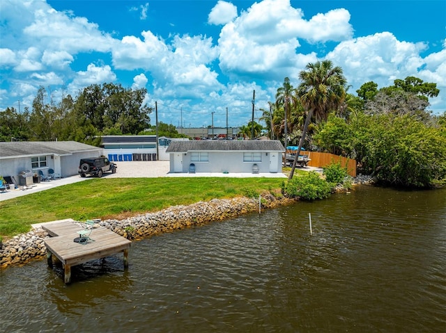 8820 Rocky Creek Dr, Tampa, FL 33615 - back of house featuring a yard and a water view