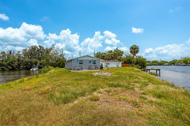 8820 Rocky Creek Dr, Tampa, FL 33615 - view of yard with a dock and a water view