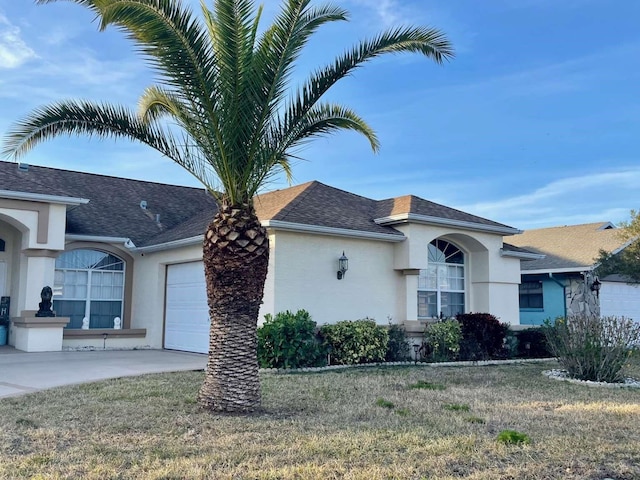 view of front facade with a garage and a front lawn