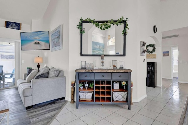 living area with light tile patterned flooring and baseboards