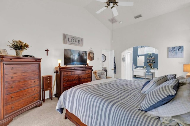 bedroom featuring visible vents, arched walkways, a ceiling fan, light colored carpet, and lofted ceiling