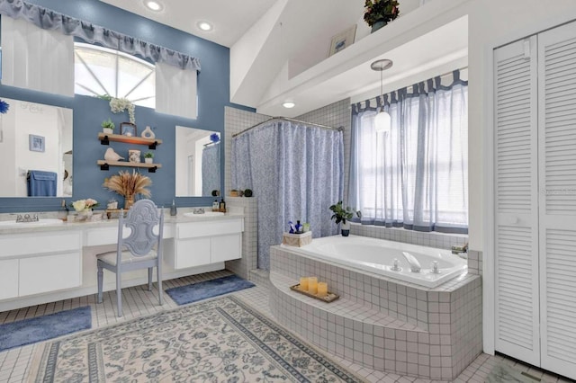 bathroom with a bath, curtained shower, plenty of natural light, and a closet