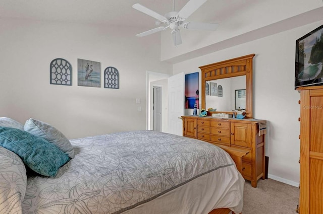 carpeted bedroom with vaulted ceiling, a ceiling fan, and baseboards