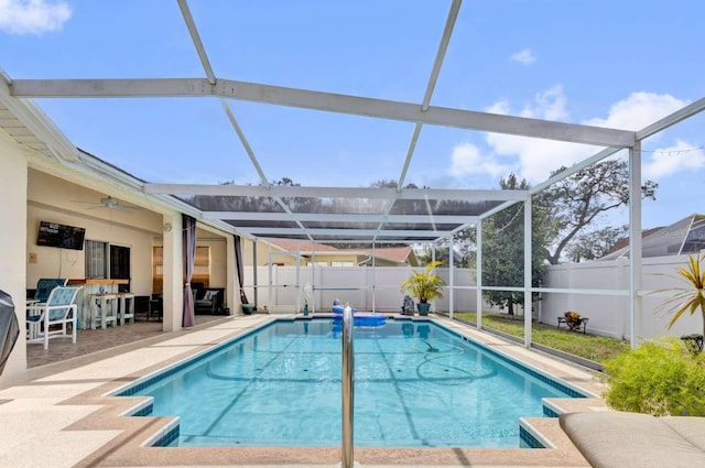 view of swimming pool featuring a lanai, a patio area, a fenced backyard, and a fenced in pool