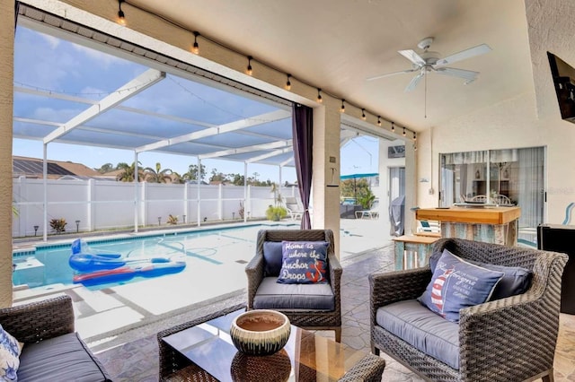 view of patio / terrace with a lanai, outdoor lounge area, fence, a ceiling fan, and a fenced in pool