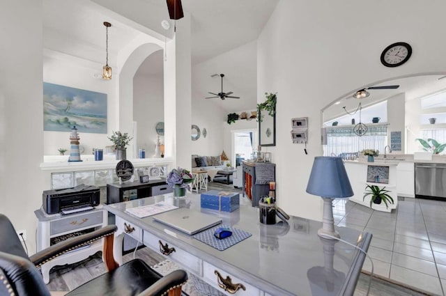 tiled home office featuring a sink, high vaulted ceiling, and a ceiling fan