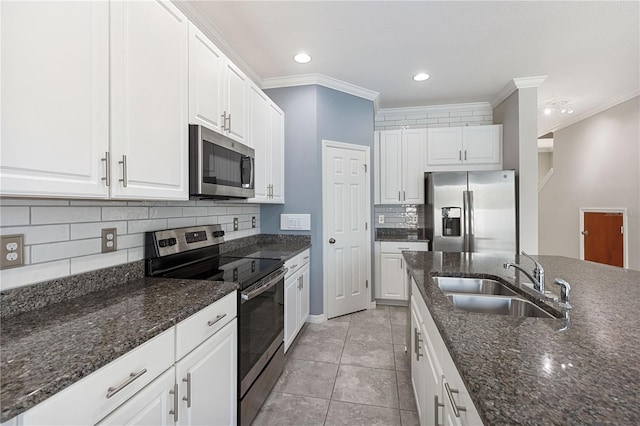 kitchen with white cabinetry, stainless steel appliances, and sink