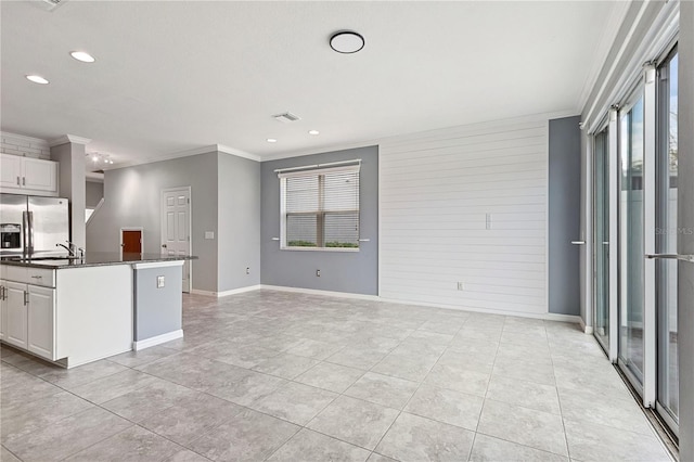 kitchen with white cabinetry, sink, crown molding, and stainless steel fridge with ice dispenser