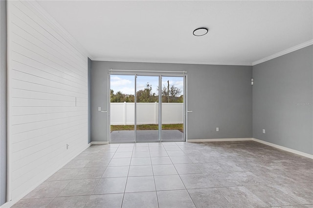 tiled empty room featuring ornamental molding