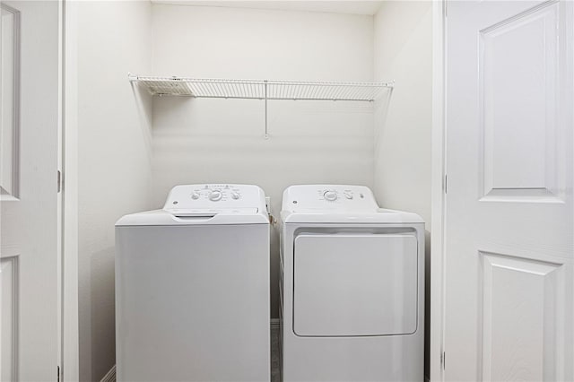 washroom with independent washer and dryer