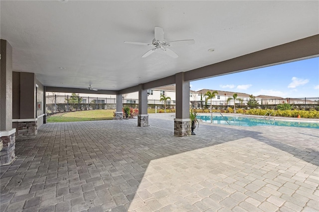 view of patio / terrace featuring a fenced in pool and ceiling fan