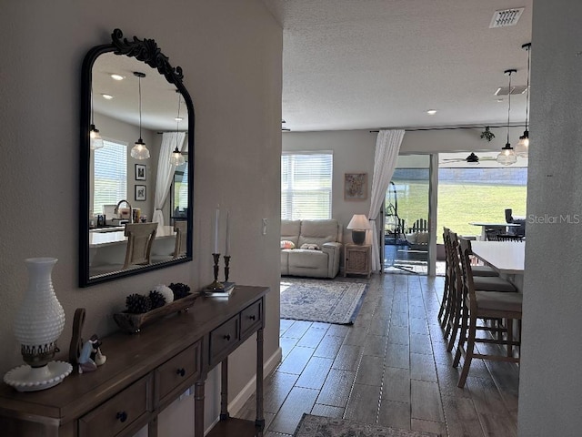 interior space featuring a textured ceiling and ceiling fan