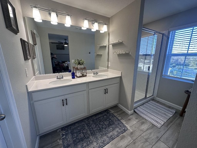 bathroom with ceiling fan, vanity, and an enclosed shower